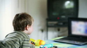 stock-footage-little-boy-watching-cartoons-at-laptop-and-eating-apples